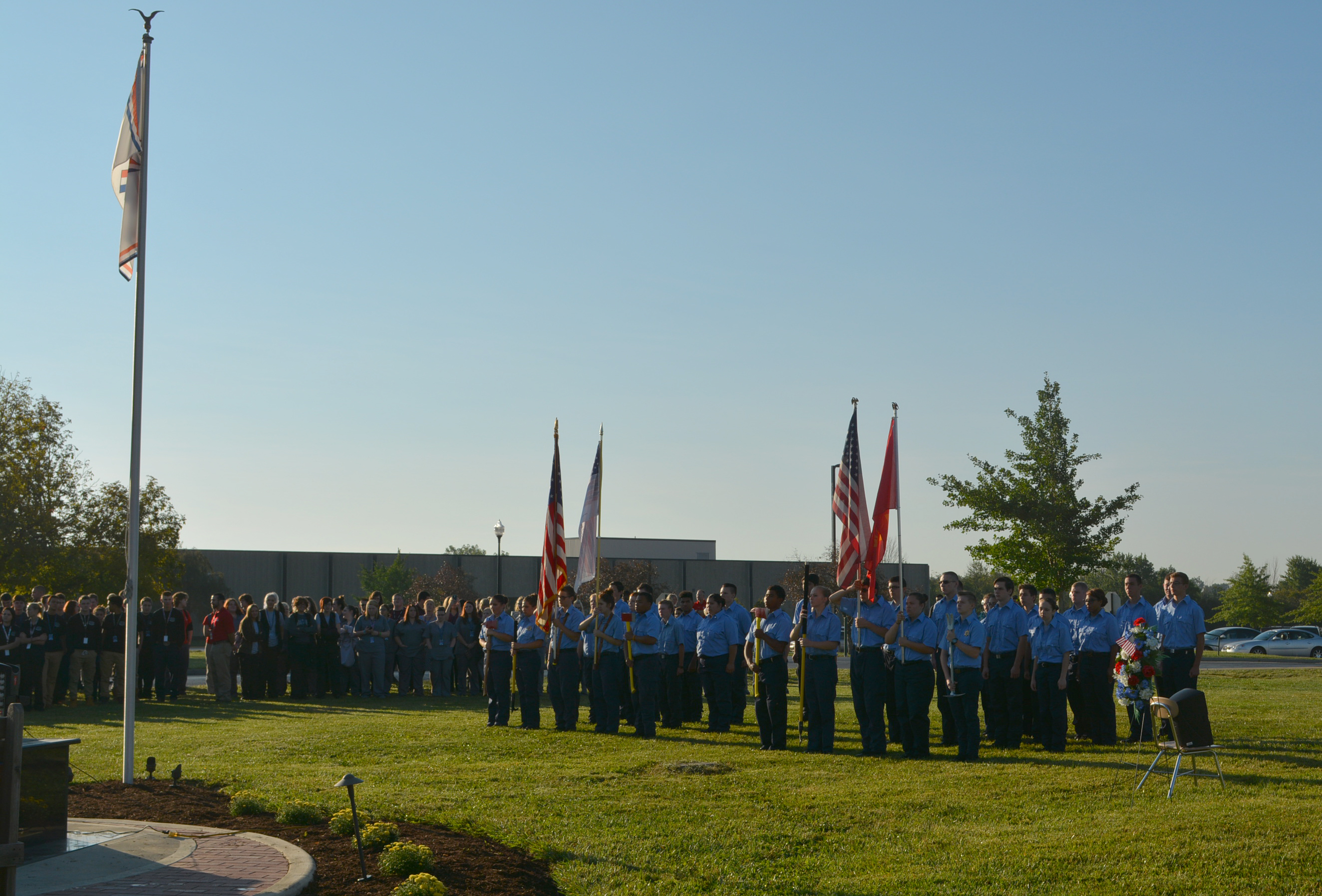 Public safety students stand in group in front of the memorial